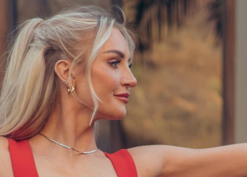 Photo of a blonde model doing yoga in a red top